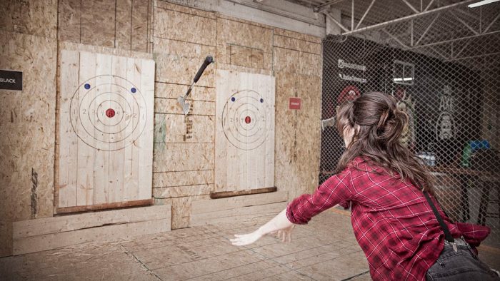 Coach Kiri demonstrating axe throwing