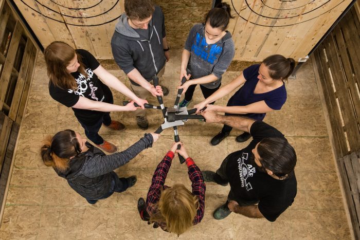 Axe throwers gathering together