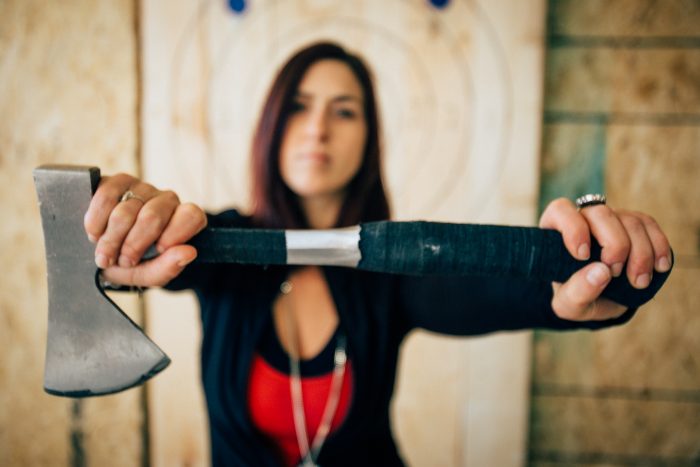 Axe throwing coach Hannah with axe 