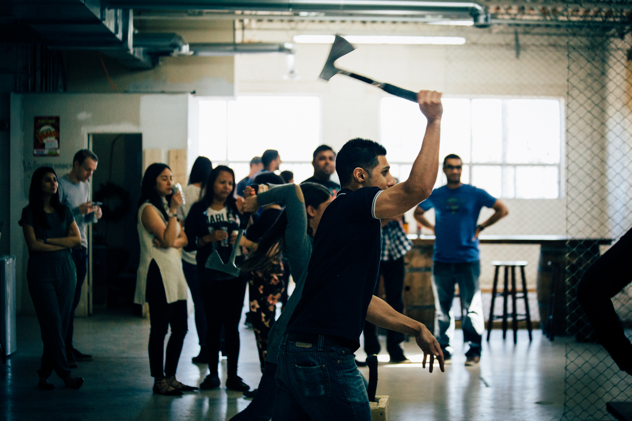 two axe throwers throwing