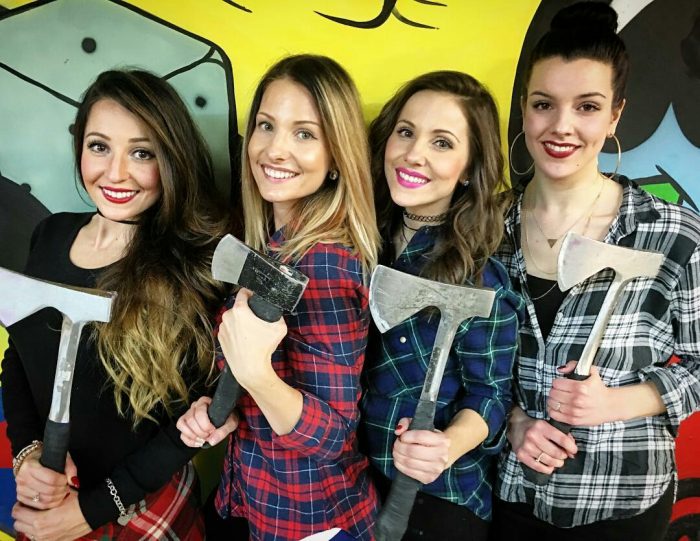 Girls holding axes at Bad Axe Throwing 