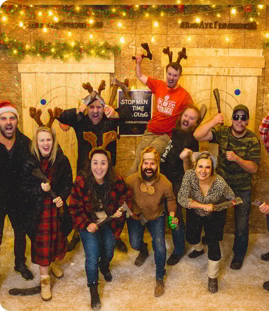 Group enjoying axe throwing holiday event